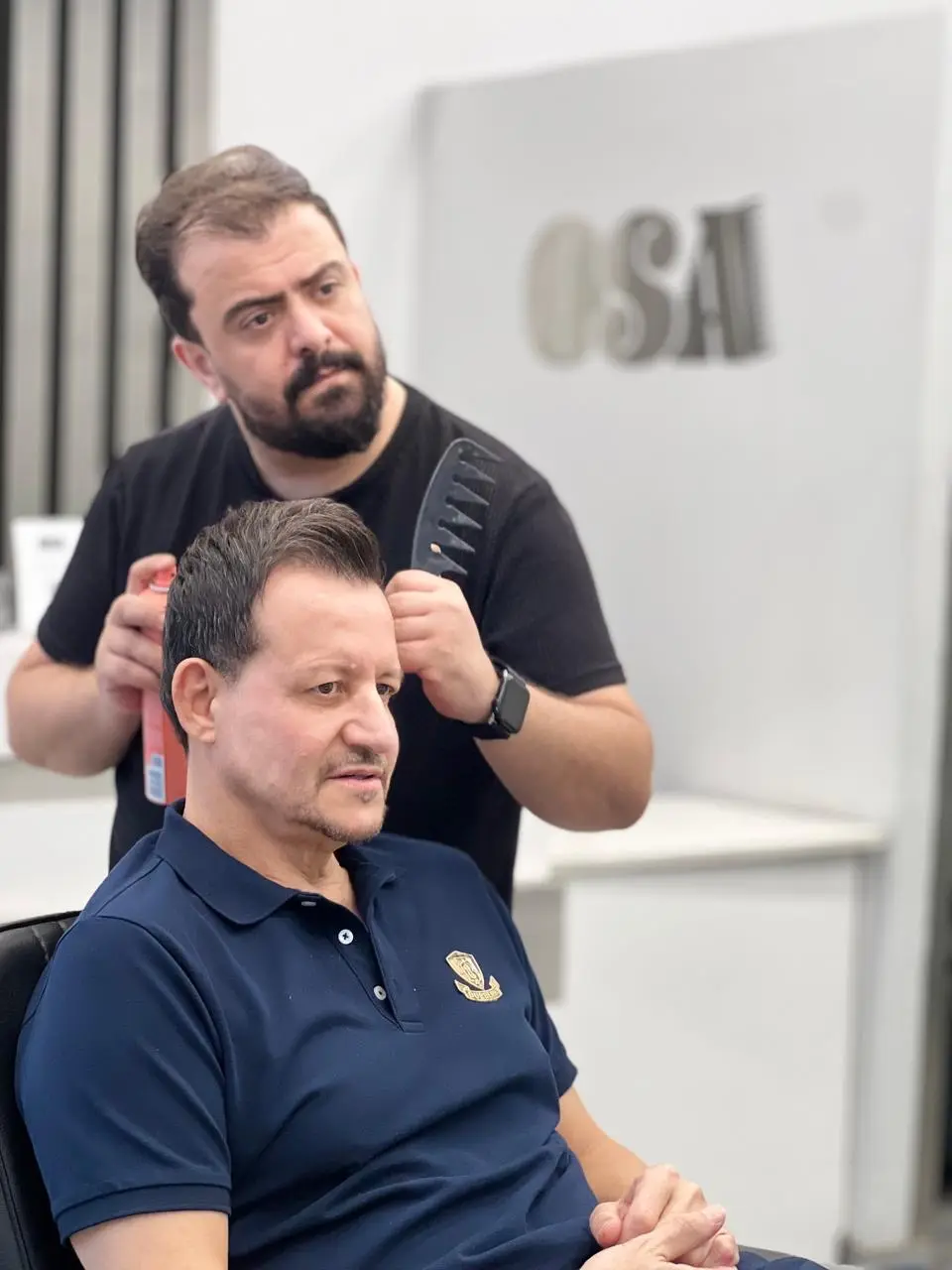 Barber blending a fade with clippers at OSA Gents Salon, Jumeirah