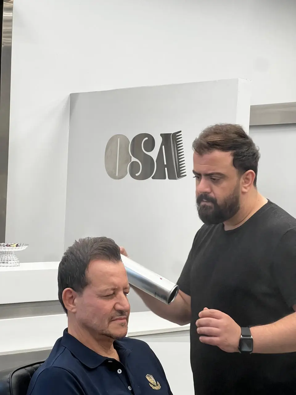 Grooming a client in the barber chair at OSA Gents Salon, Dubai