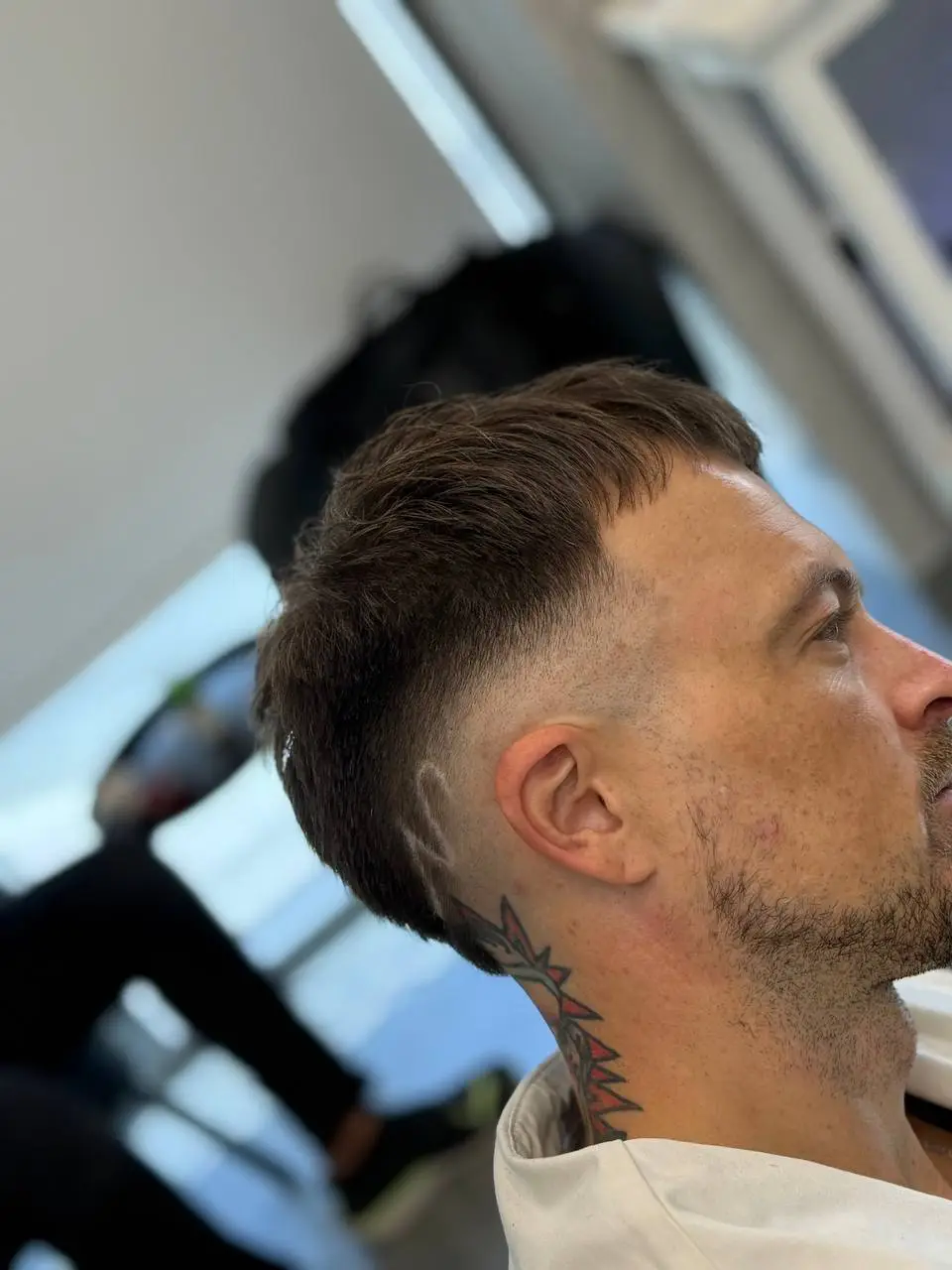 Barber blending a fade with clippers at OSA Gents Salon, Dubai