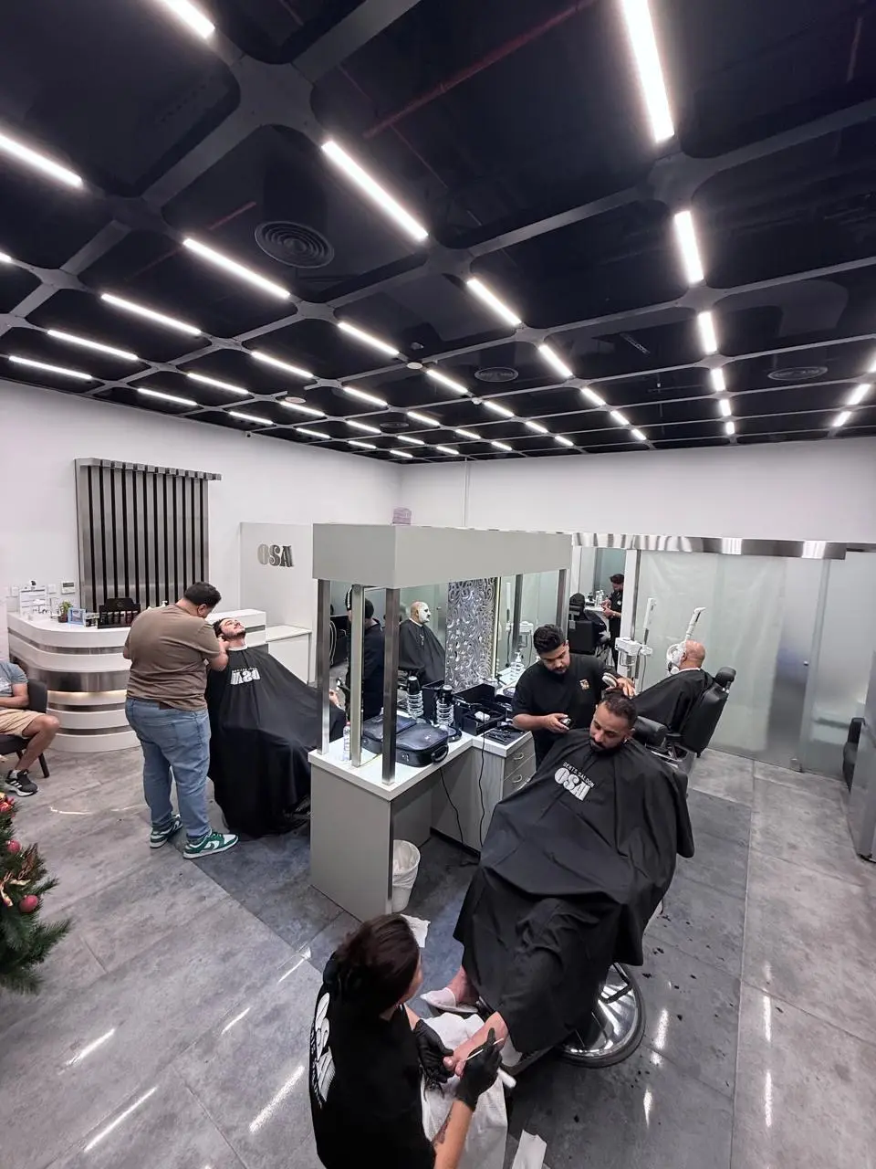 Spacious interior with styling stations at OSA Gents Salon, Jumeirah
